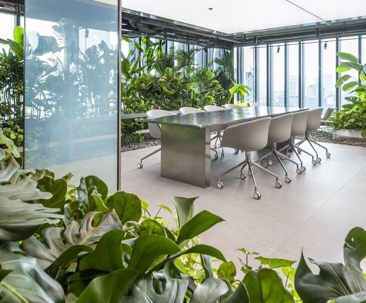 Modern office meeting room with abundant indoor plants